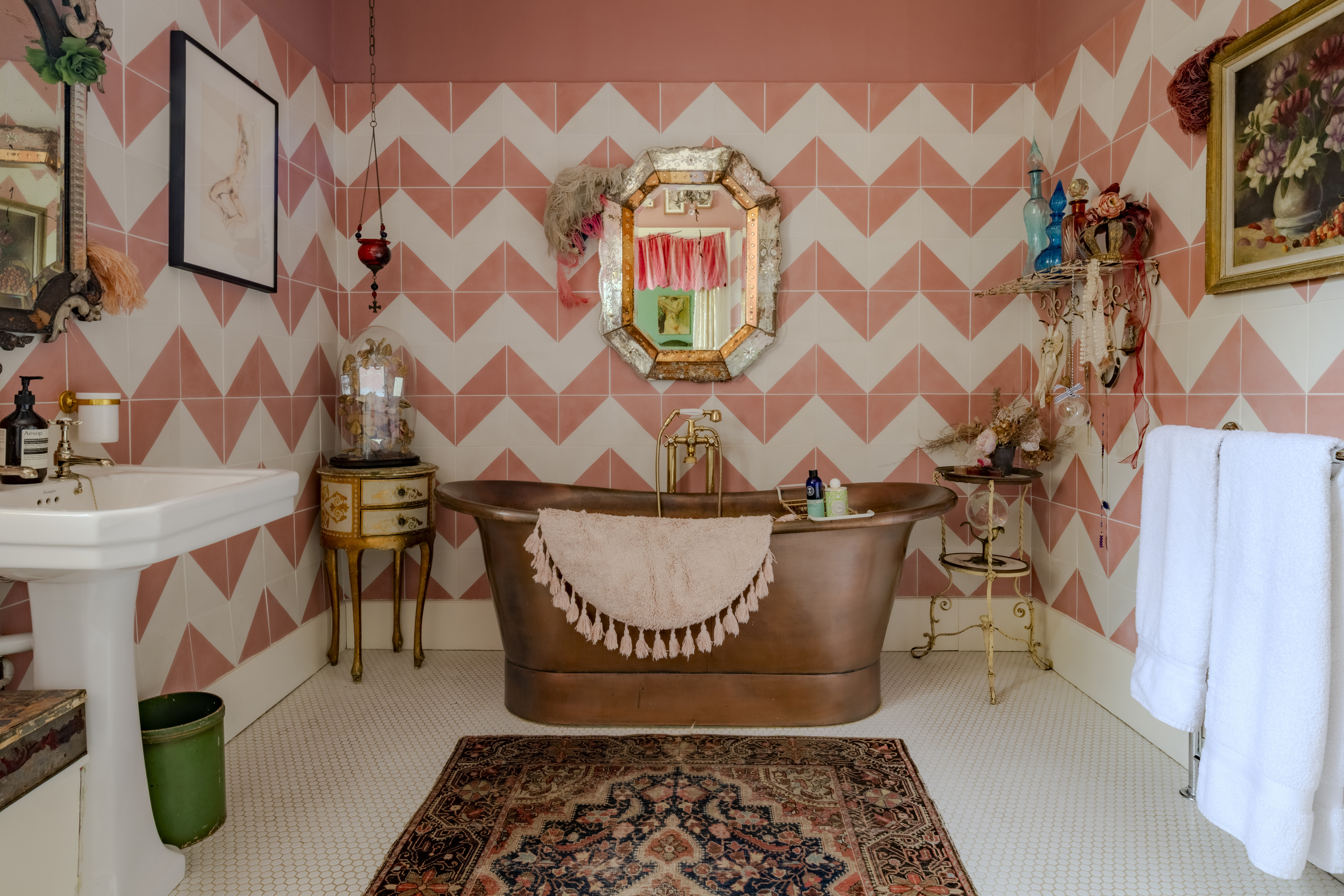 Bathroom featuring a copper tub and pink chevron tile.