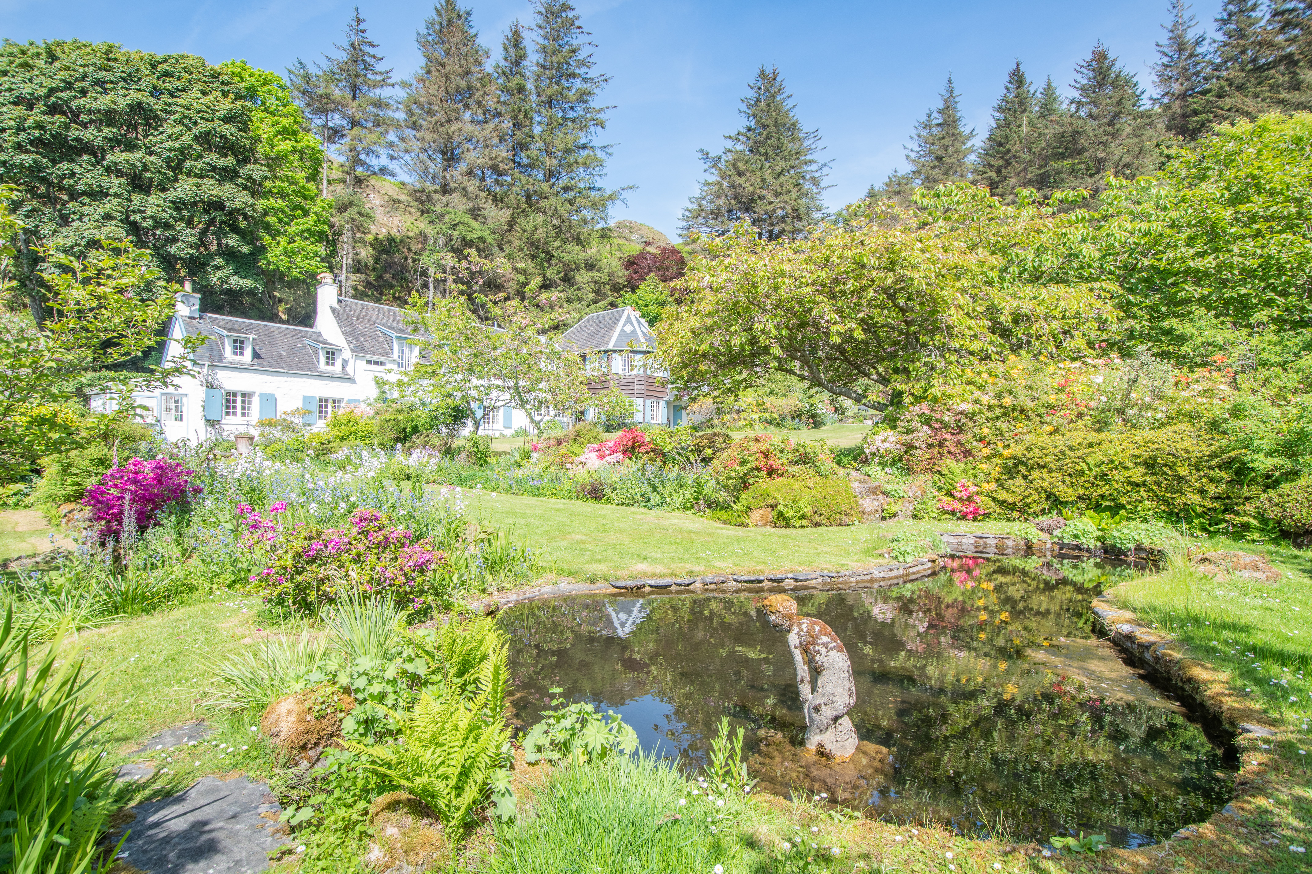 Charming houses with blue shutters and a garden pond.