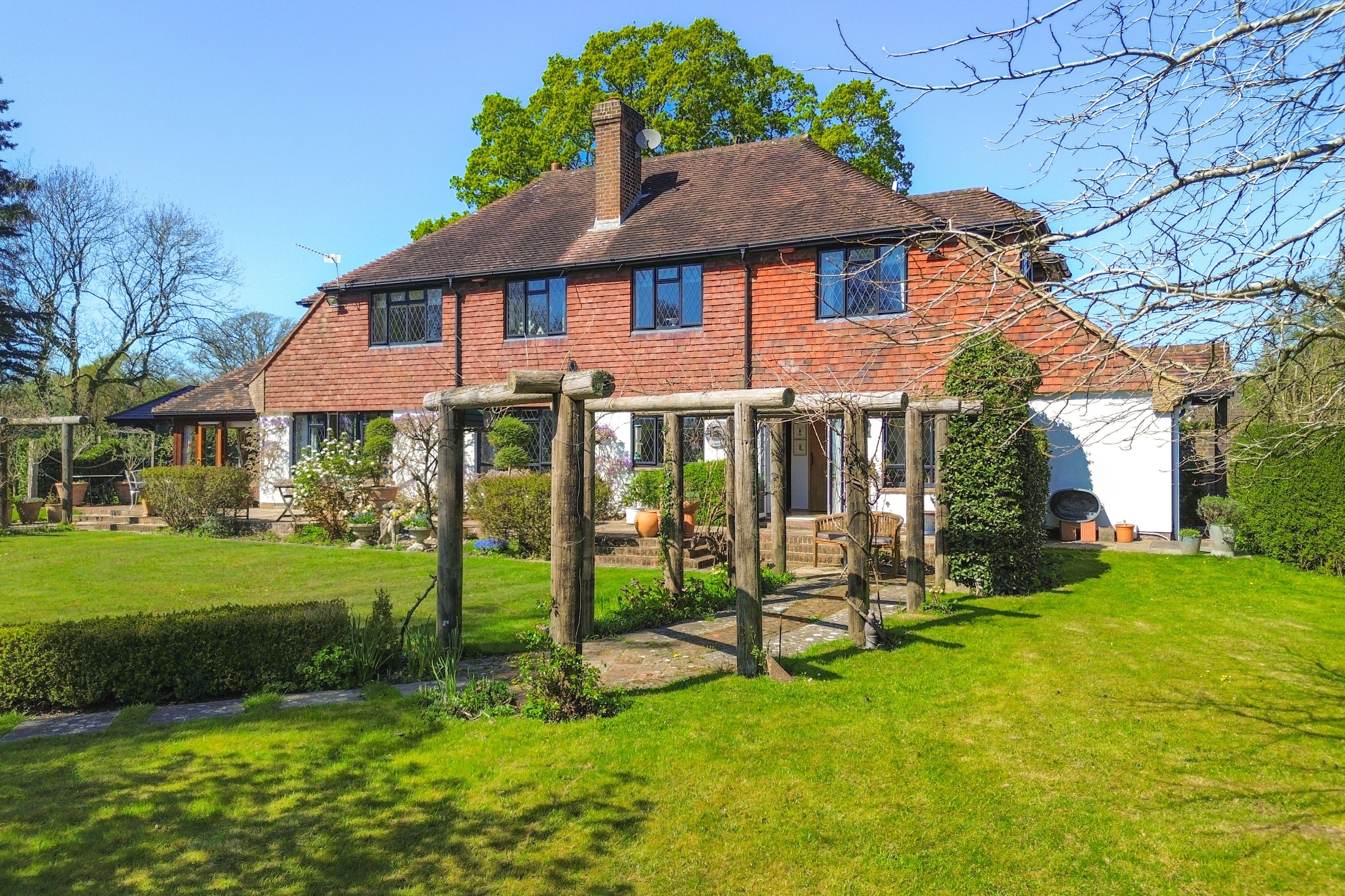 Red brick country house with extensive gardens.