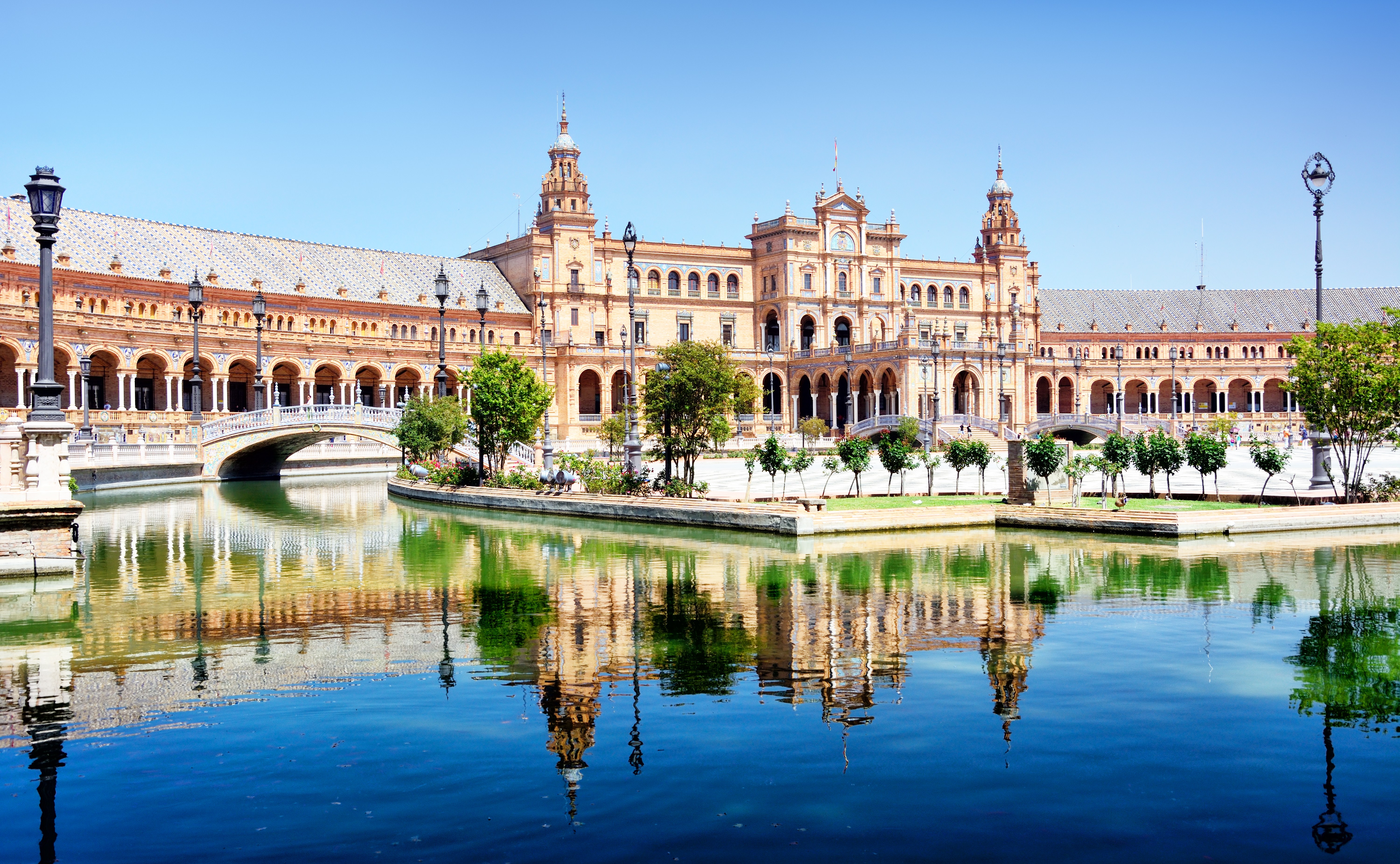 Plaza de España in Seville, Spain, reflected in a canal.