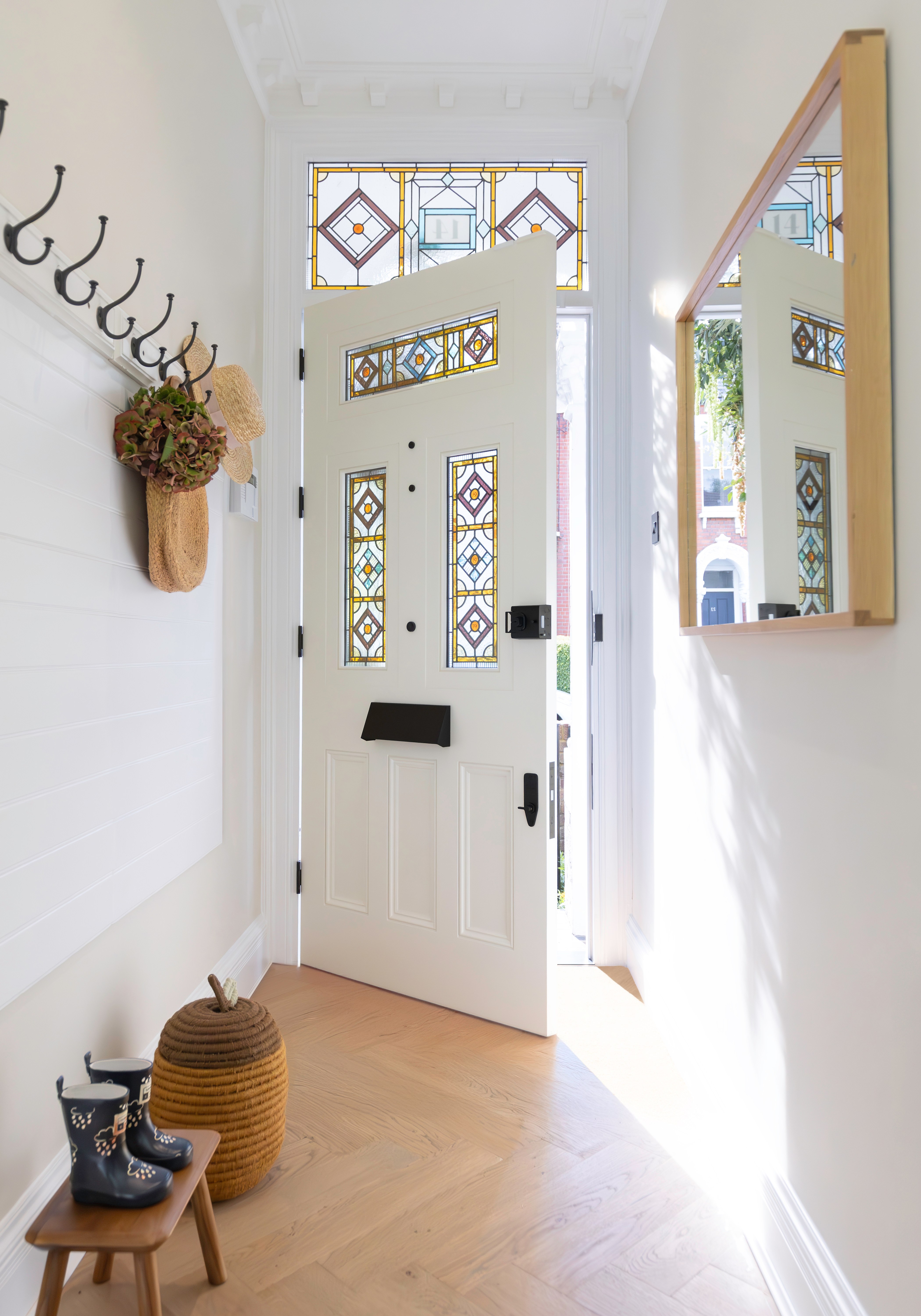 Hallway with white door and stained-glass window.