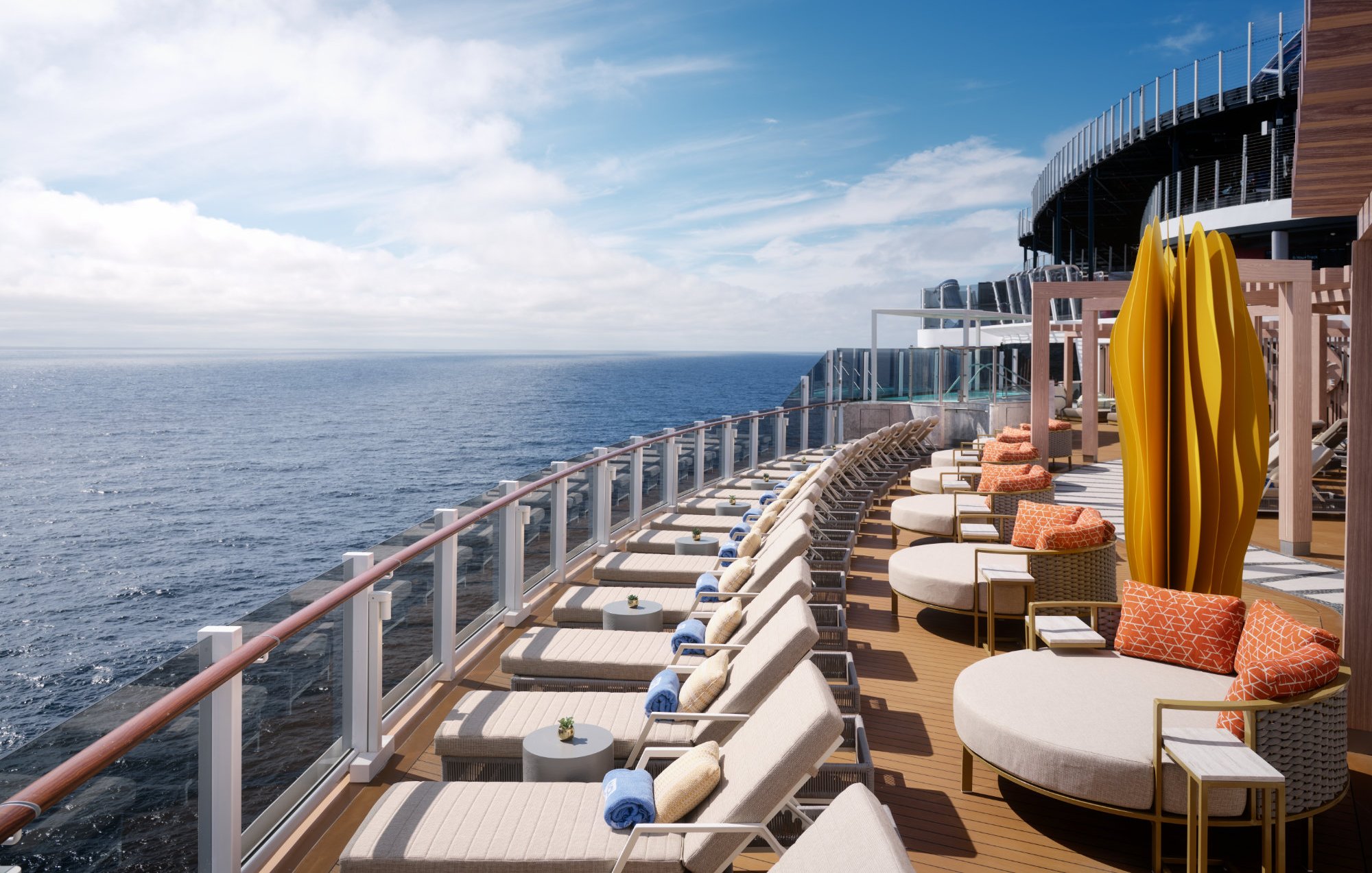 Norwegian Viva cruise ship deck with lounge chairs and daybeds overlooking the ocean.